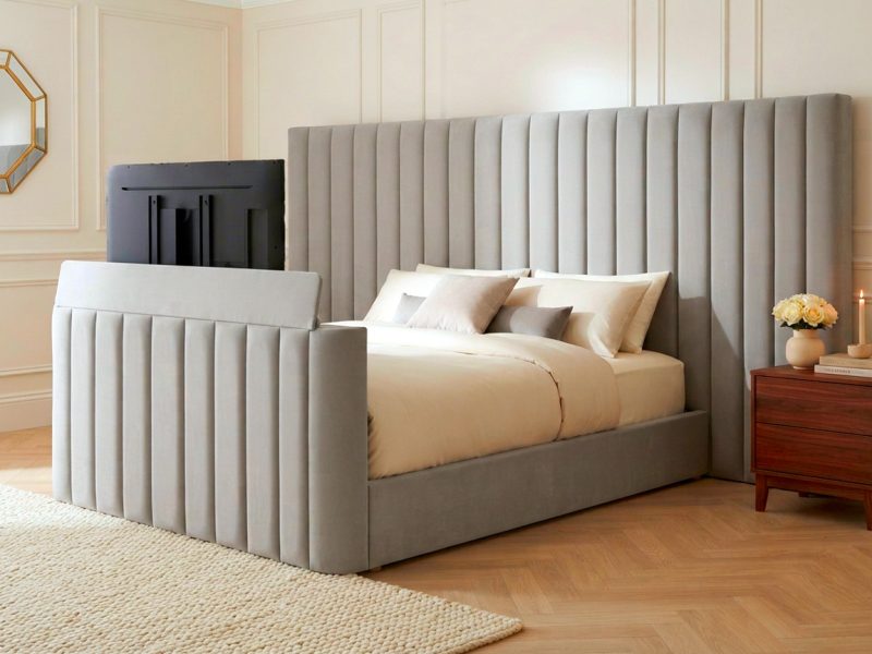 Capri TV Bed with stone plush fluted headboard and matching footboard in a modern bedroom